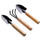 Close-up of the small trowel, hand cultivator, and garden fork from the tool set.