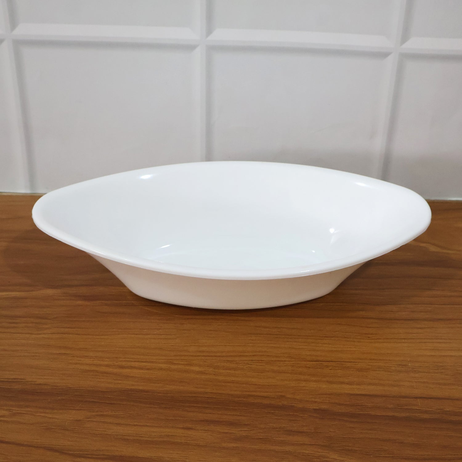 White Marin oval serving bowl measured with tape showing dimensions