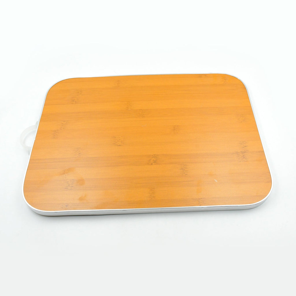 Versatile bamboo cutting board used for various kitchen tasks like slicing vegetables.