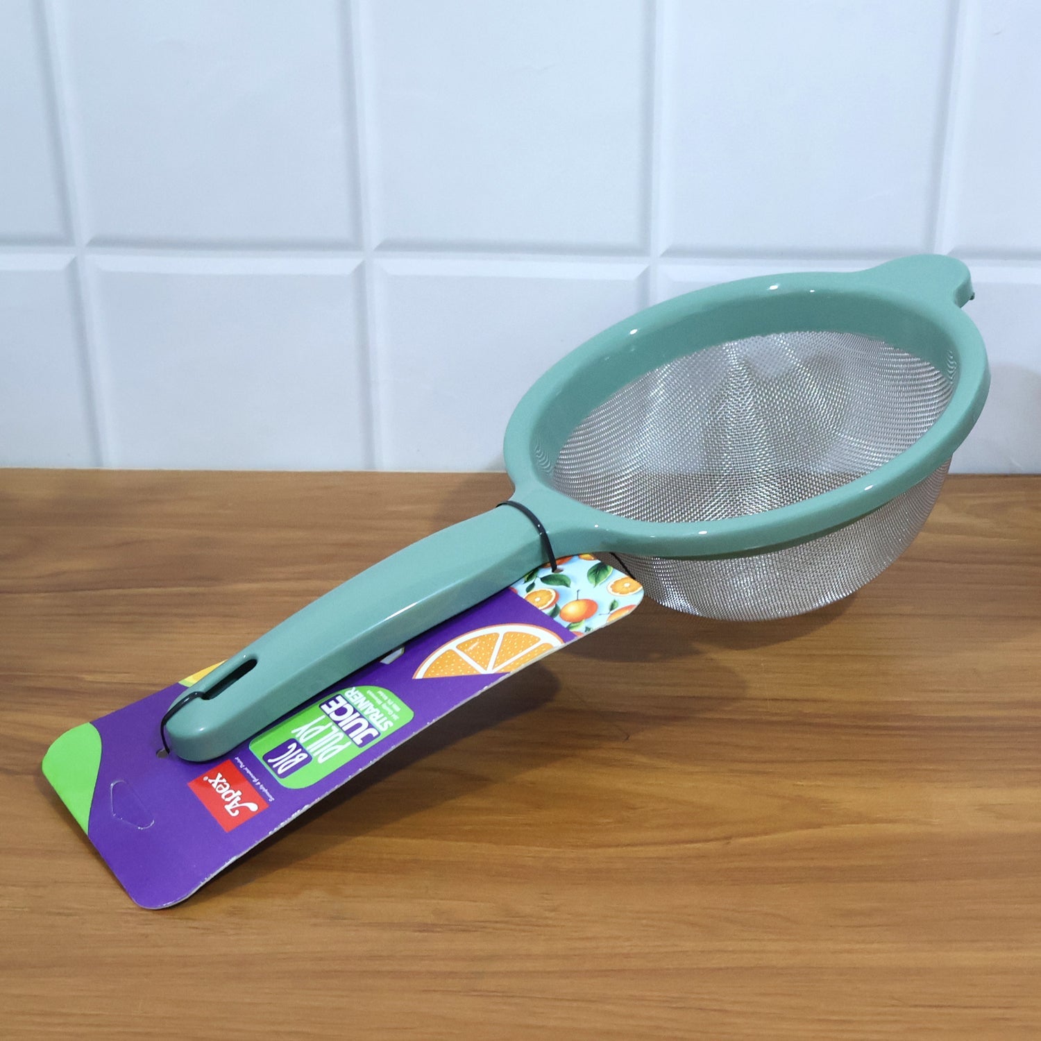 Easy-clean large kitchen strainer hanging securely by handle on kitchen hook