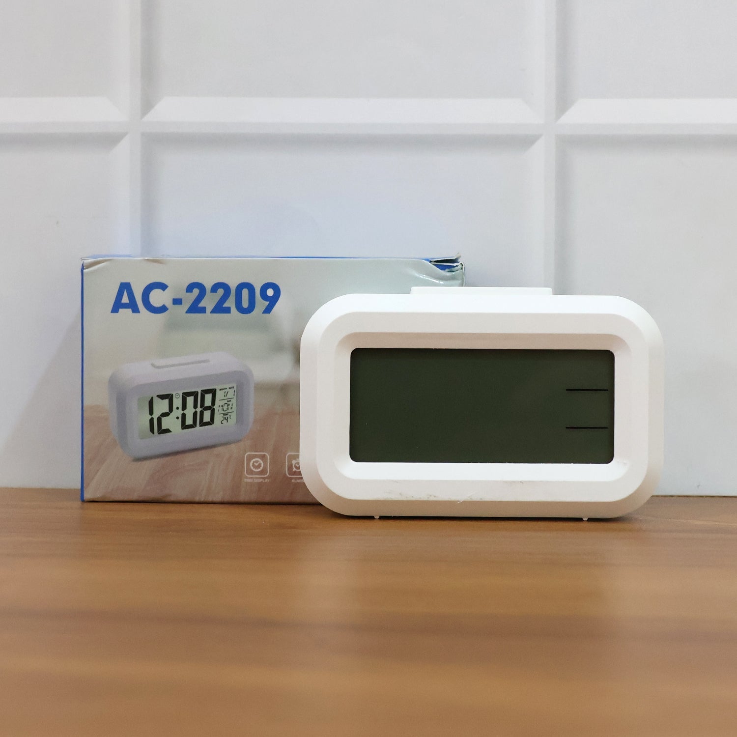 LED alarm clock on desk showing time and night light glow