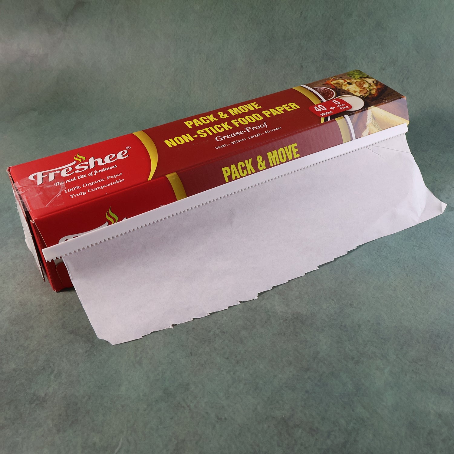 Freshee food paper roll placed beside baking trays for easy access