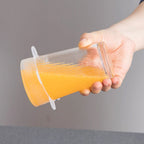 Reusable silicone lid keeping food fresh in a glass bowl inside a refrigerator.