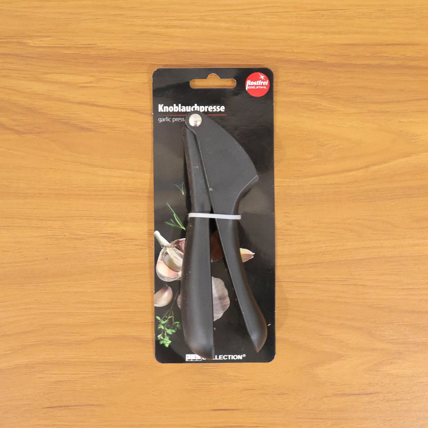 Compact handheld manual garlic press tool for efficient kitchen use