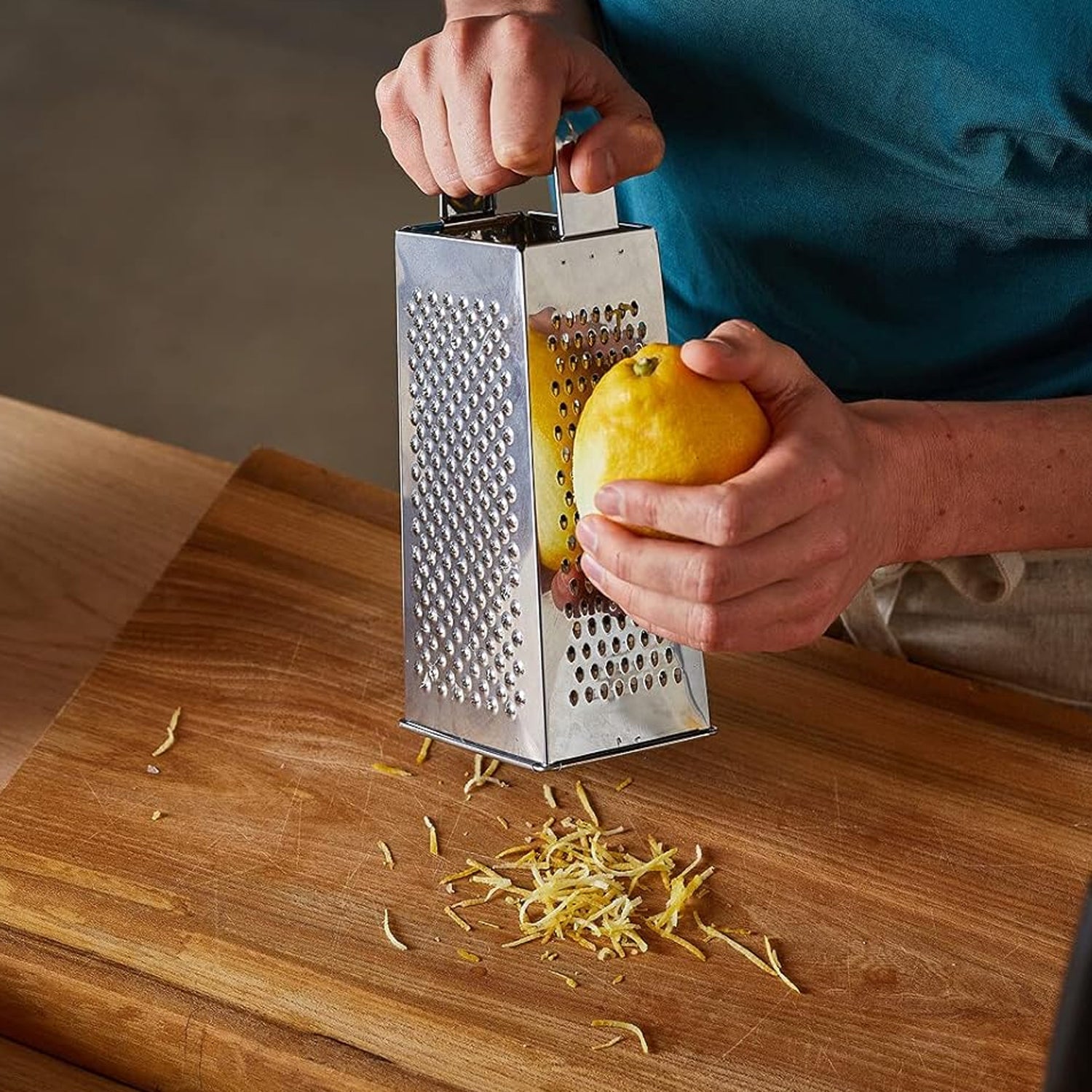Compact stainless steel food grater and slicer designed for easy storage.