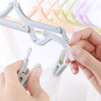 Close-up of foldable hanger showing ergonomic design and skid-proof grooves