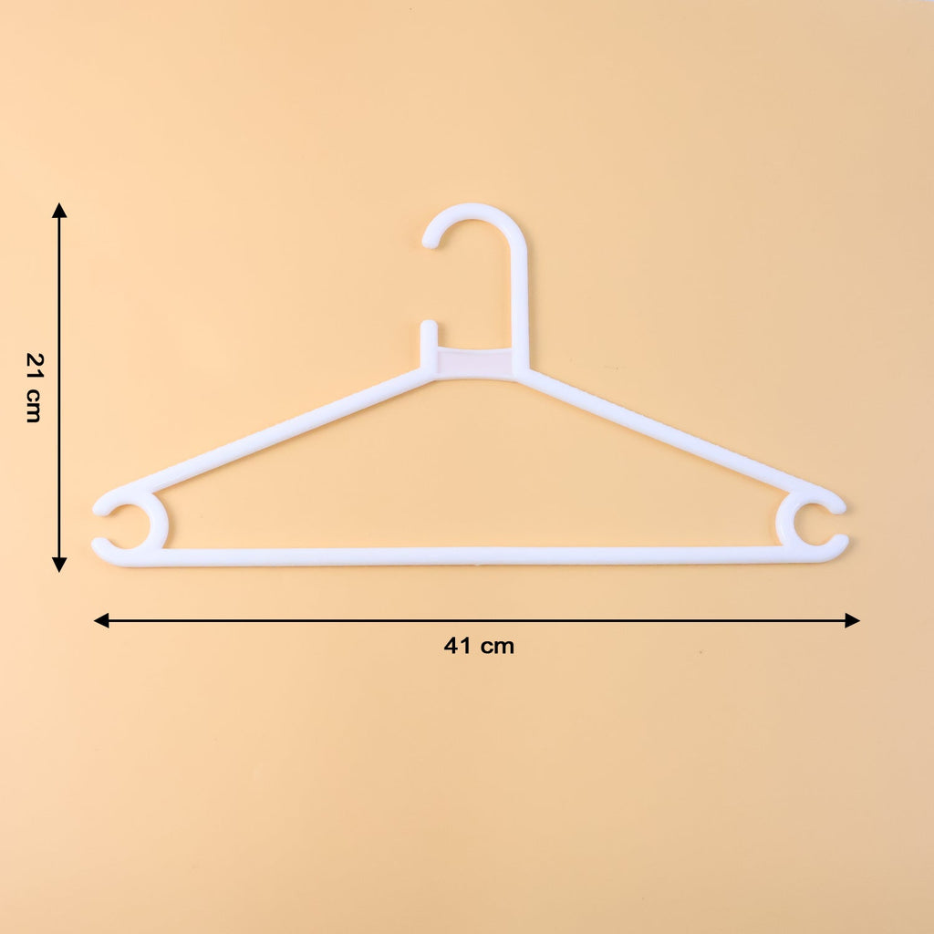 White plastic clothes hanger supporting a hanging garment