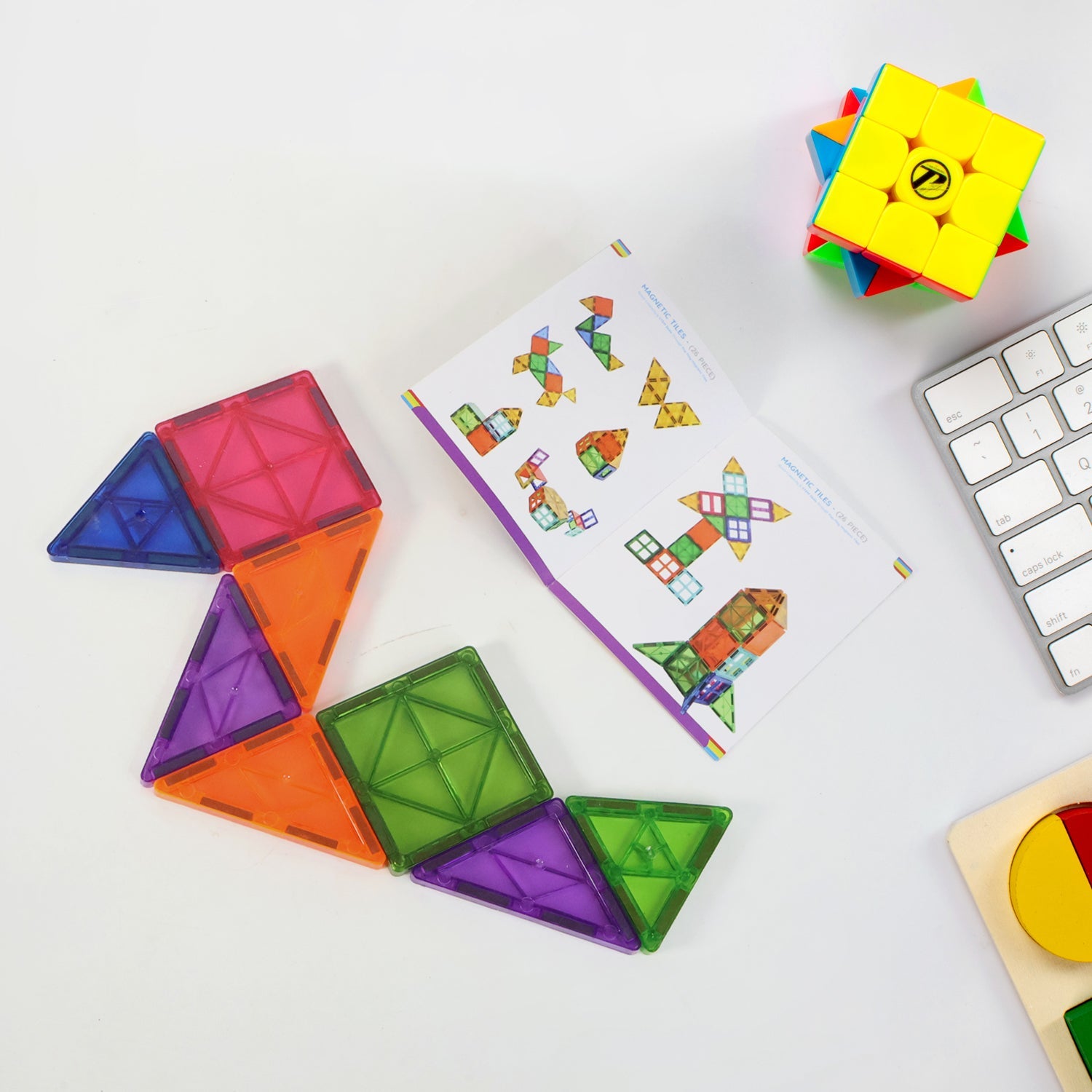 Magnetic building tiles laid out showing different vibrant shapes