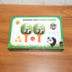 Child holding a panda-themed paddle from the hanging table tennis trainer set