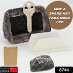 Open fake rock key hider revealing the hidden compartment for a spare key.