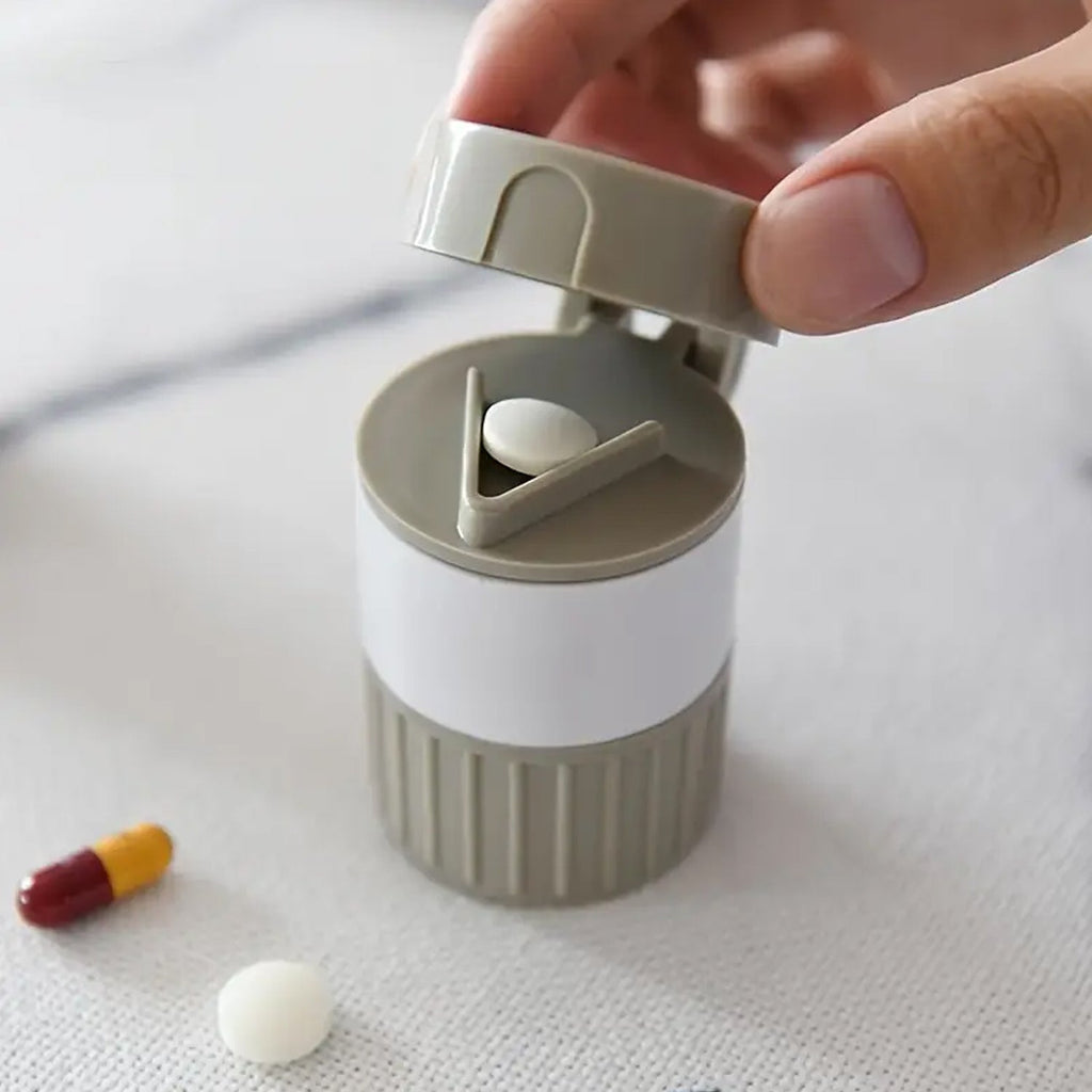 Opened Organivo medicine cutter revealing the pill cutting blade and storage areas.