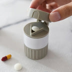 Opened Organivo medicine cutter revealing the pill cutting blade and storage areas.