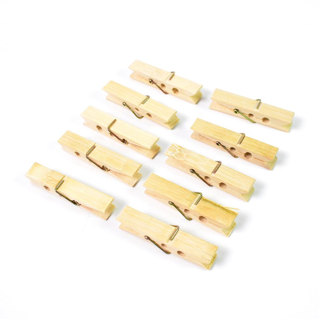 Sturdy wooden clothes pegs made from bamboo arranged for a clear product view.