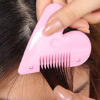 Child's hand holding pink heart-shaped safety hair scissors