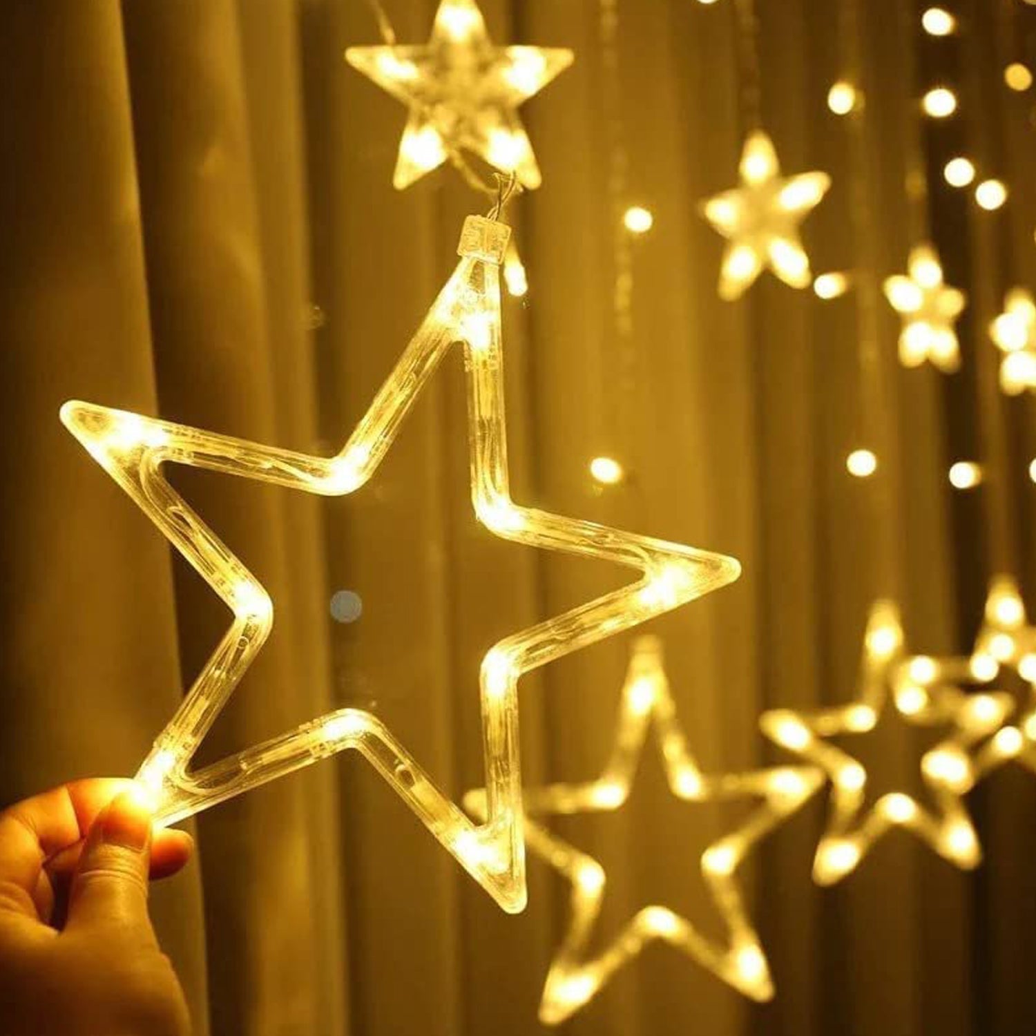 A cluster of glowing Star Curtain Lights creating a festive window display.