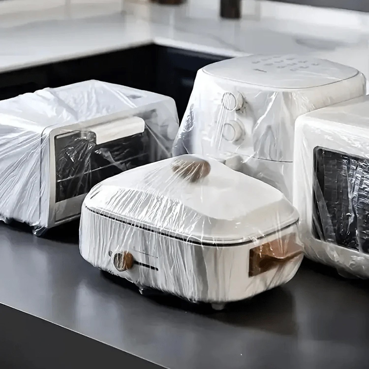 Clear plastic cover protecting a sofa from construction dust.