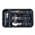 Organized stainless steel cutlery set with plastic grip handles in tray