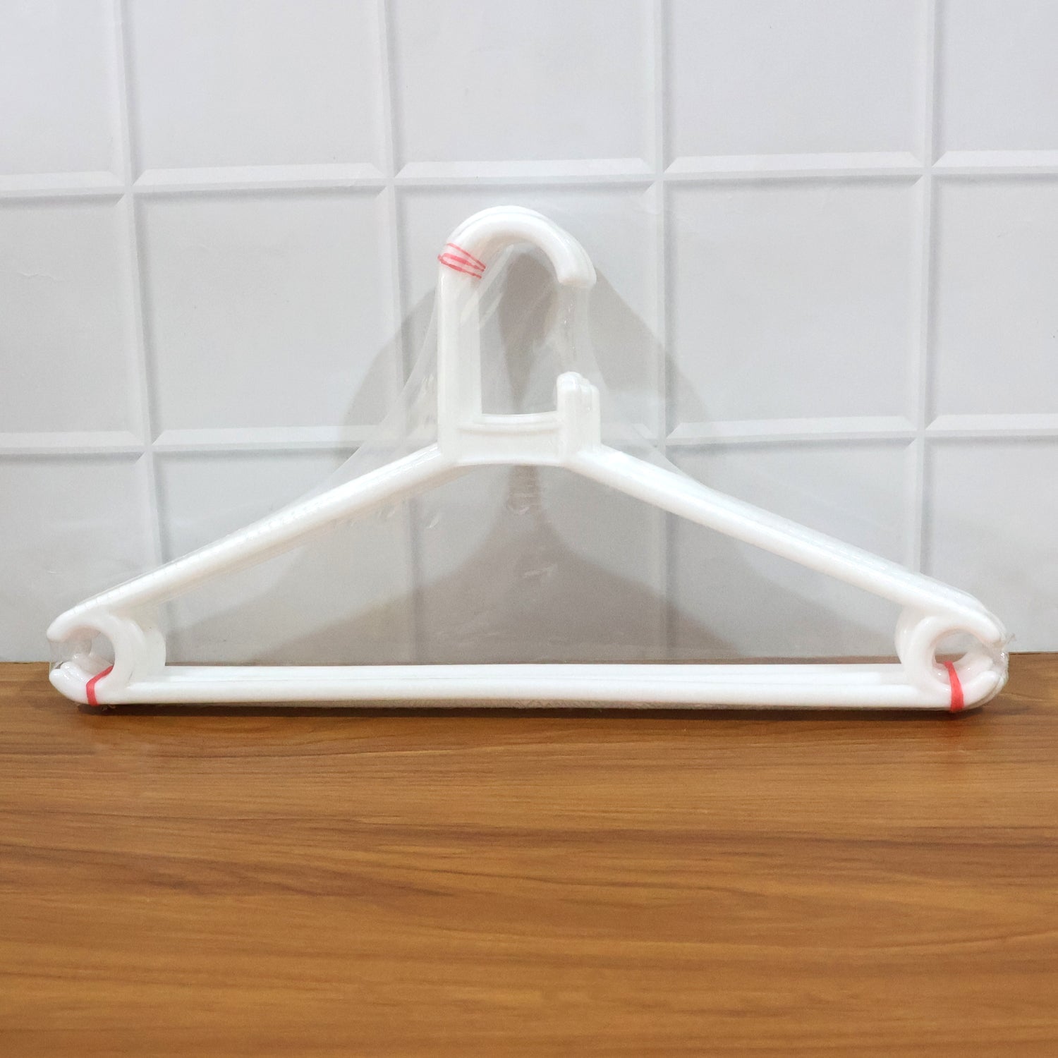 Dimensions diagram showing length, width, and height of plastic clothes hanger
