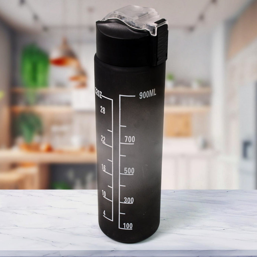 Black motivational water bottle with straw and time markers against a light background.