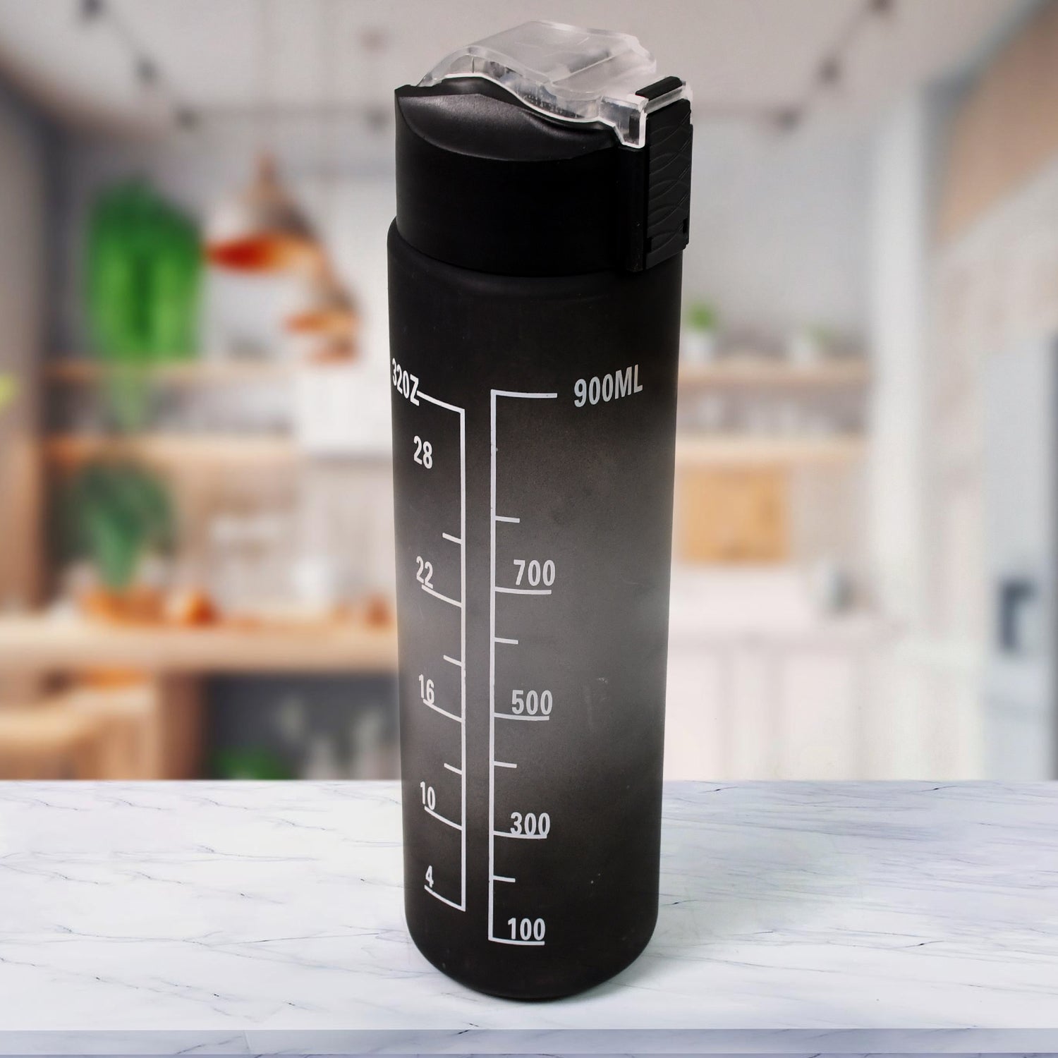 Black motivational water bottle with straw and time markers against a light background.