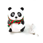 Child's hand gently touching the soft silicone panda night light to change colours.