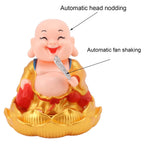 The Solar Buddha Car Ornament demonstrating its gentle head and hand movement.