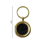Decorative gold plated keychain with black pendant, stylish and functional.