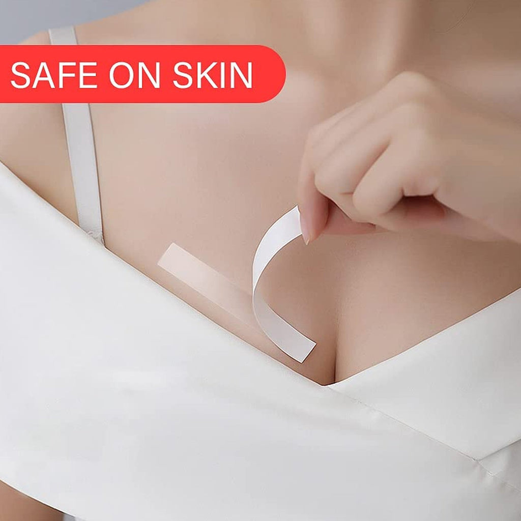 A female hand applying a clear fashion tape strip to secure a garment.
