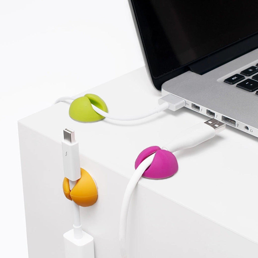 Table cable management clips creating an organized charging station area.