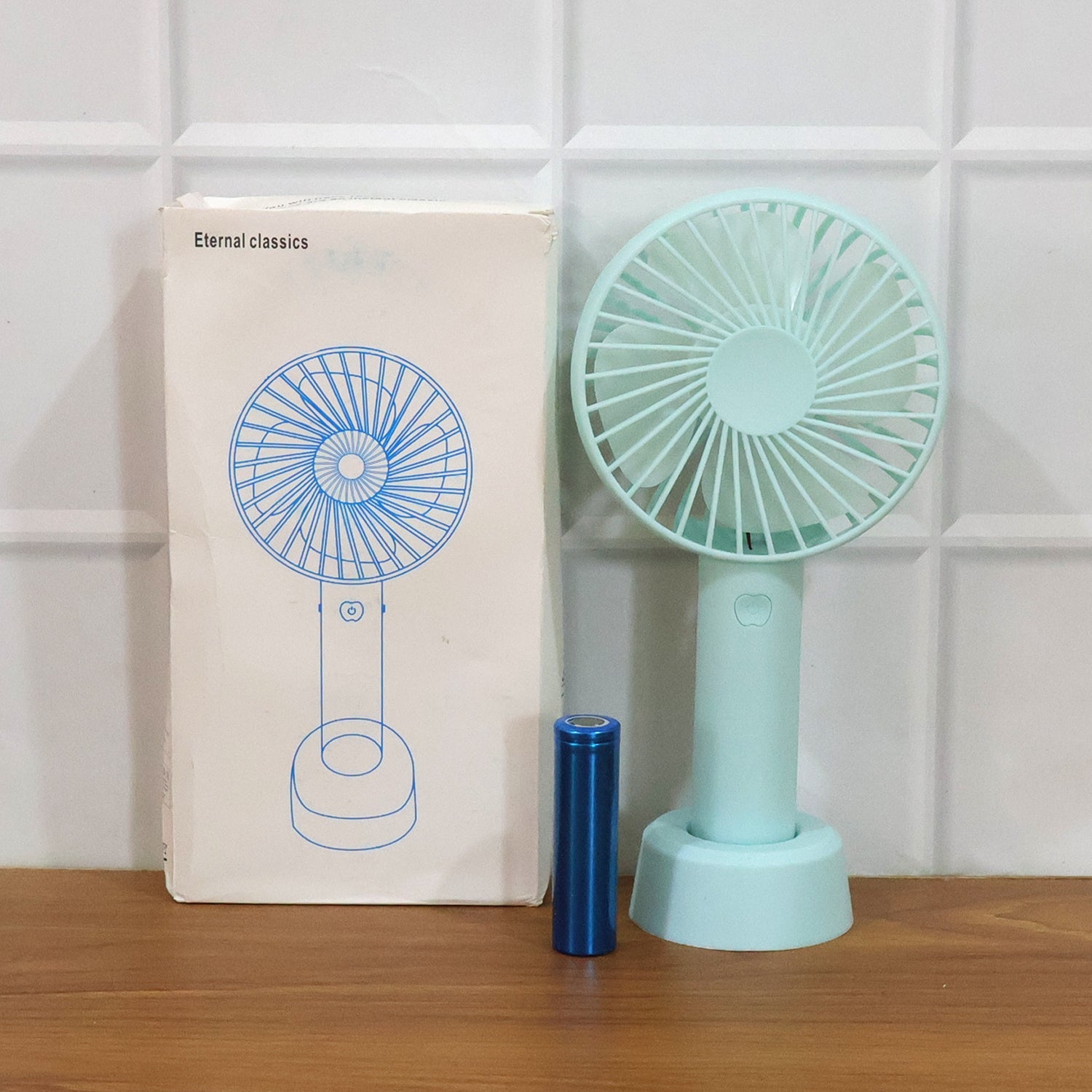 Back view of the versatile travel fan, showing its smooth casing and compact form.
