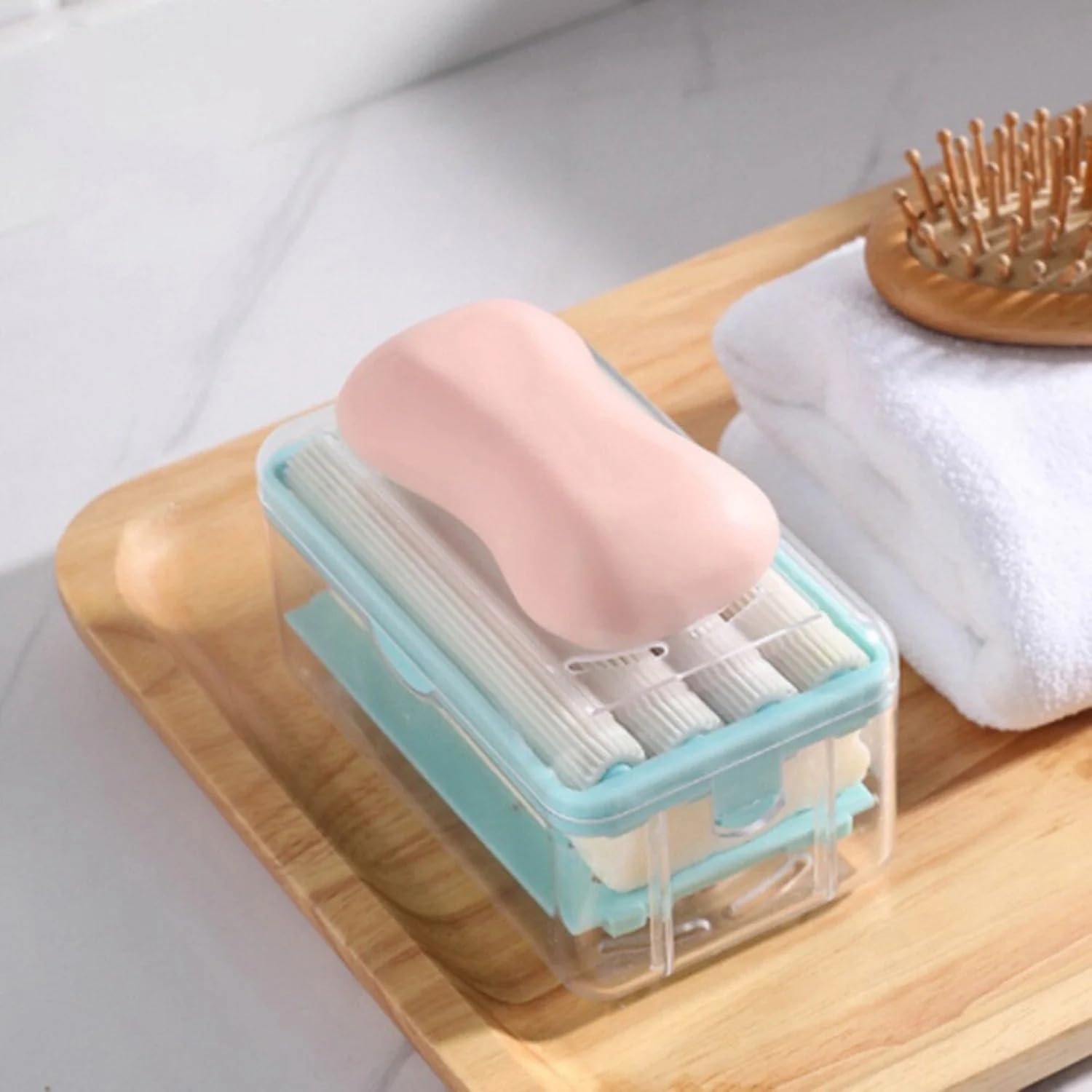 Portable detergent bar holder with a built-in roller brush, ideal for travel.