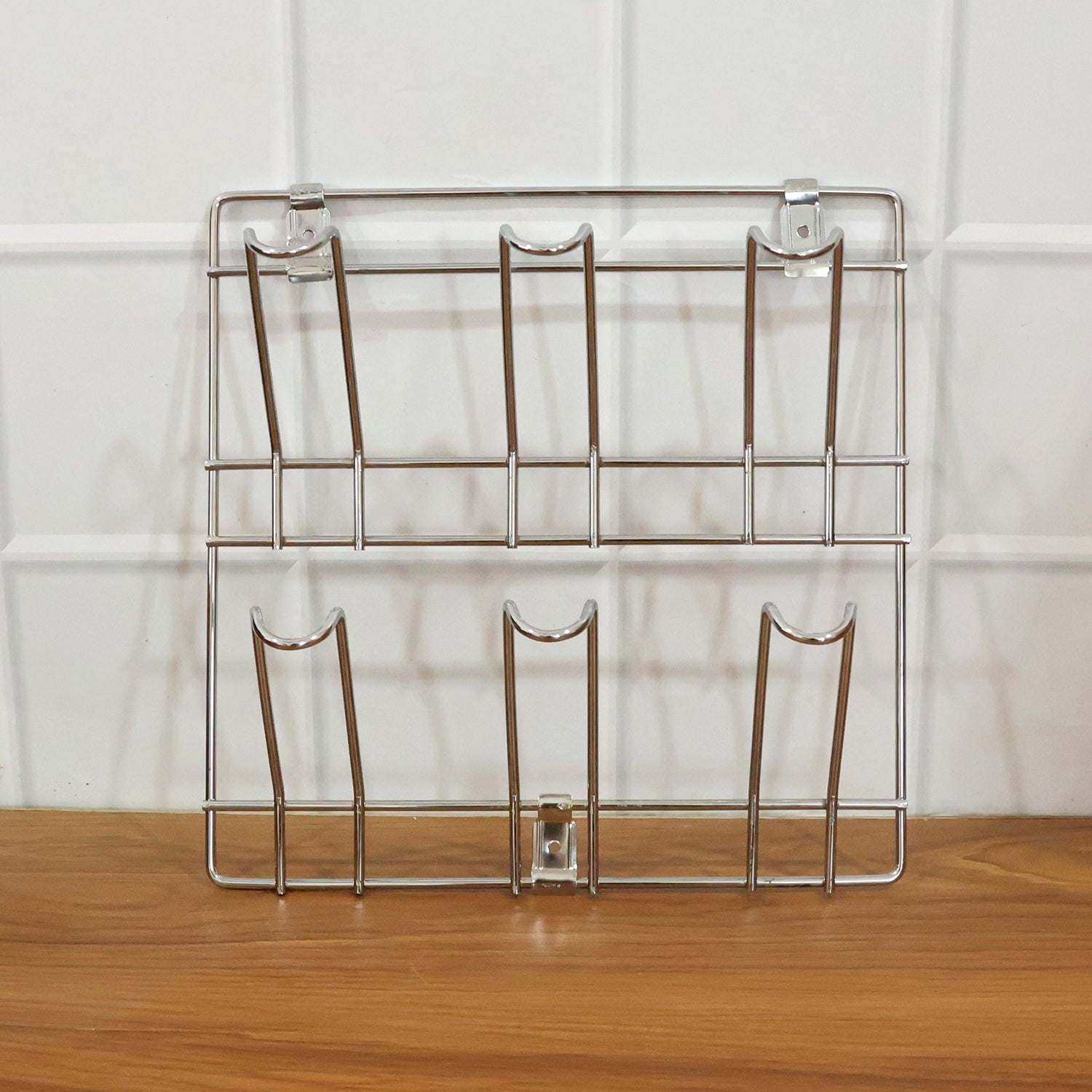 Close-up of stainless steel wall-mounted mug and cup holder rack