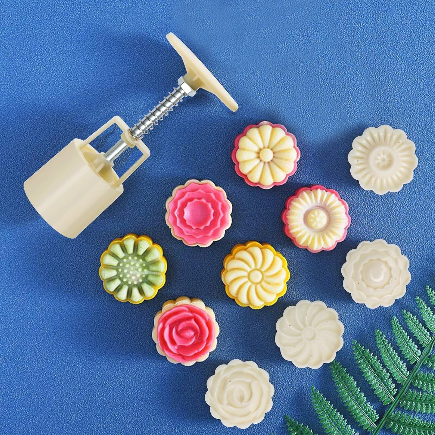 Hand using mooncake press mold to make a detailed floral patterned pastry