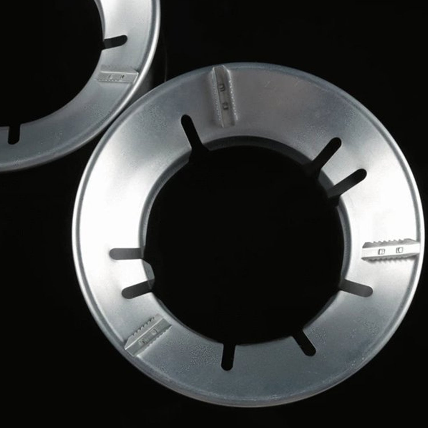 Energy-saving Gas Stove Stand placed on a burner for efficient cooking.