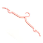Small, space-saving portable clothes hangers in use, demonstrating their compact design.