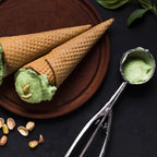 Stainless steel ice cream scoop with an easy-release trigger mechanism.