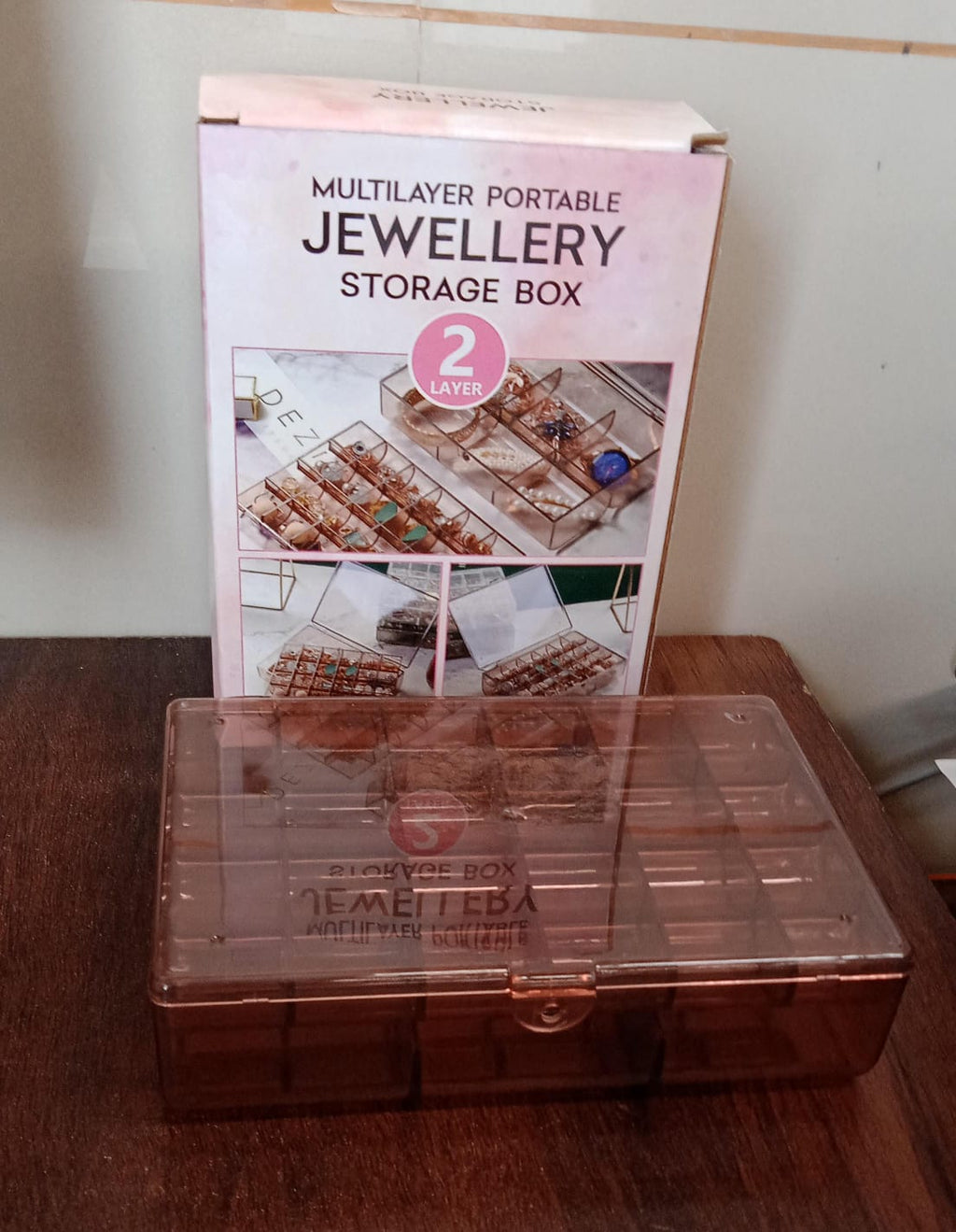 Compact clear acrylic storage box with a secure latch, showcasing its portability.