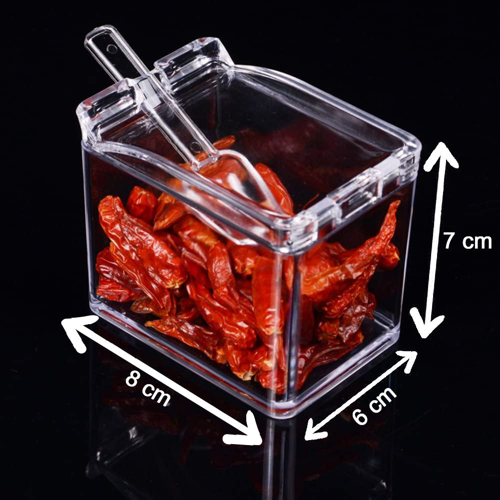 Multi-compartment clear acrylic spice box with spoons.