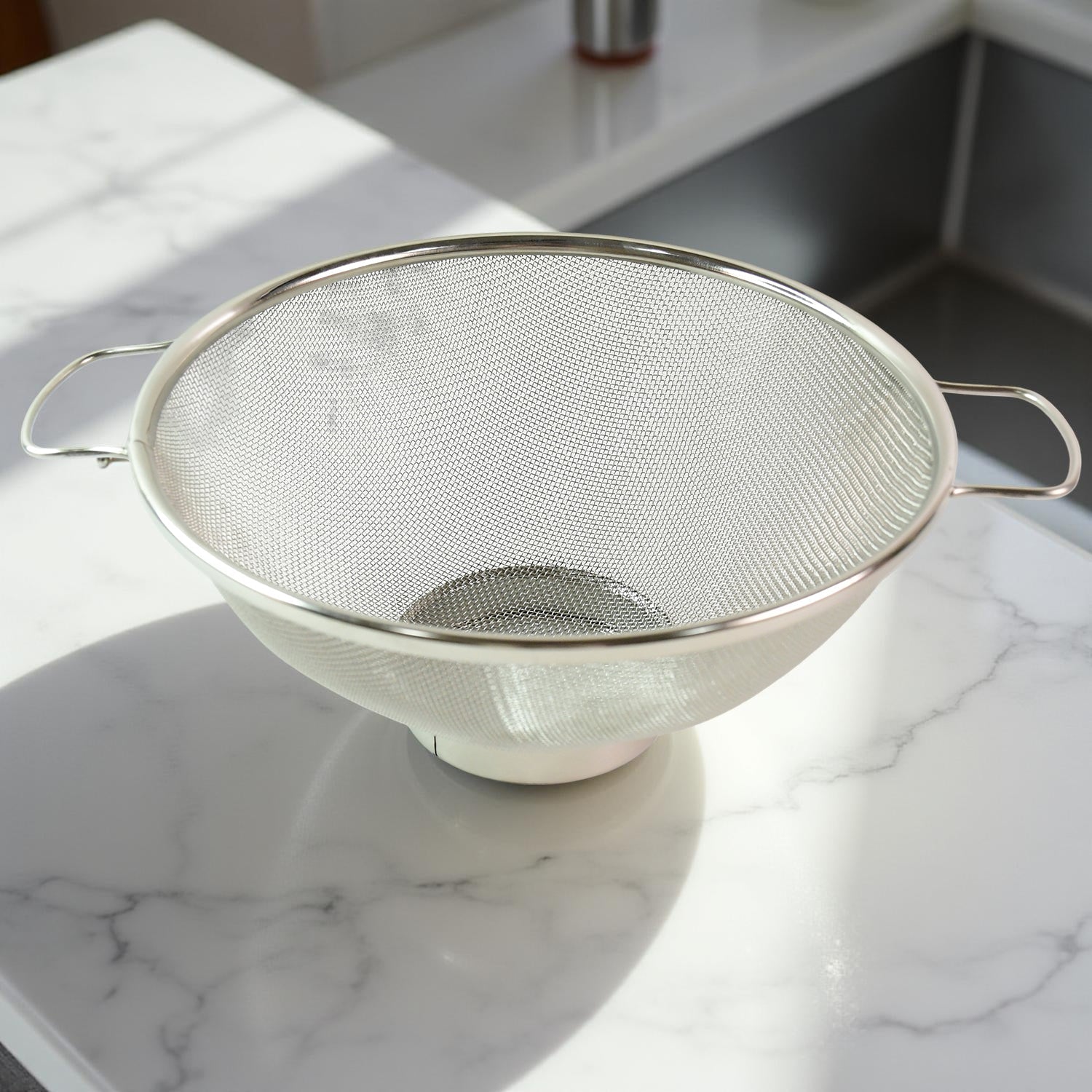 Dual ergonomic welded handles on stainless steel colander for easy grip