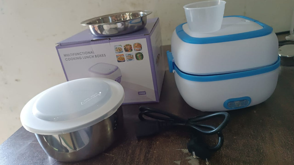 Electric Lunch Box showing the included egg steaming tray and an additional food container.