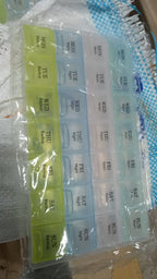 Transparent seven-day pill storage box with four rows for organized tablet keeping.