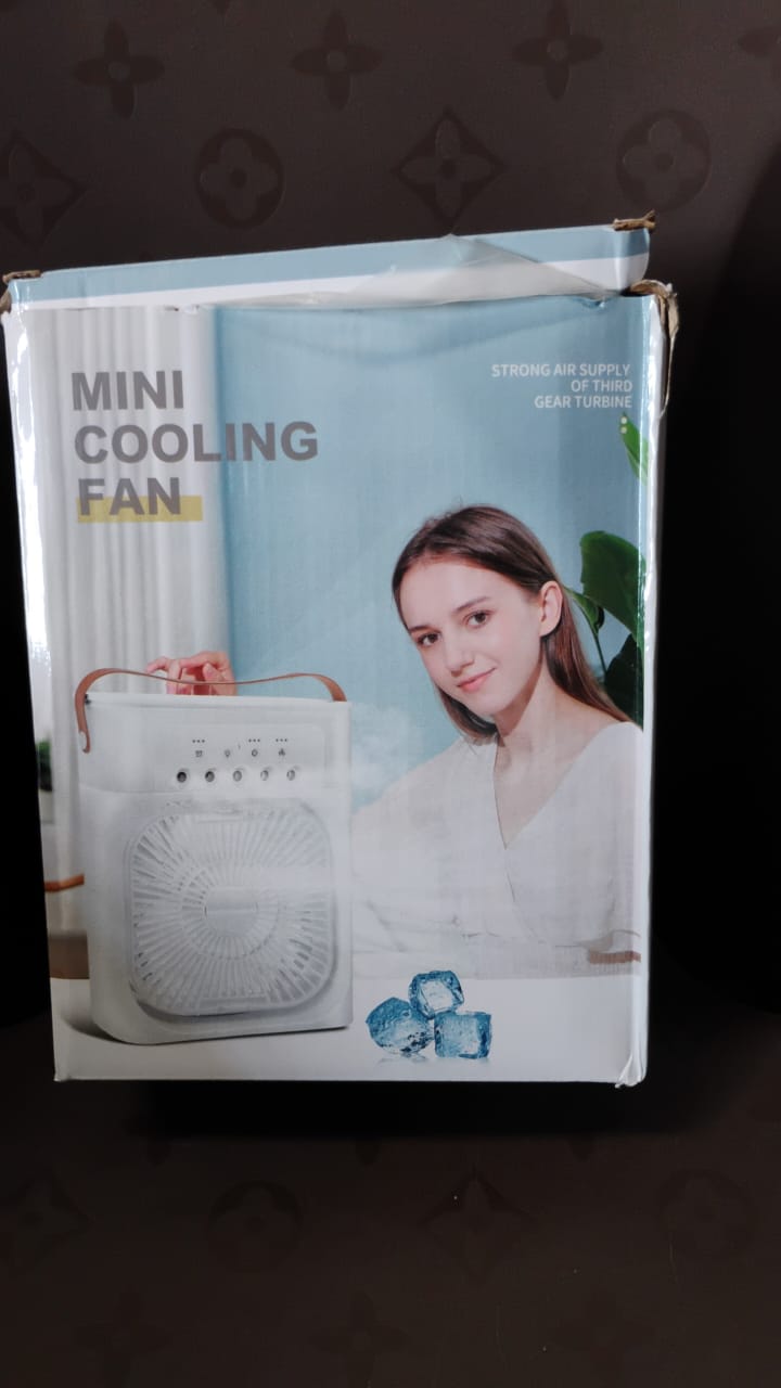 In-use lifestyle shot of portable air cooler fan with LED light