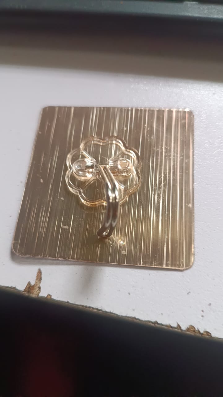 Clear adhesive hook fixed on smooth wall surface