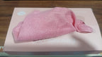 Stack of vibrant microfiber cleaning cloths neatly arranged inside the dispenser box.