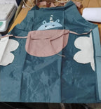 Model wearing cute animal cartoon apron while cooking