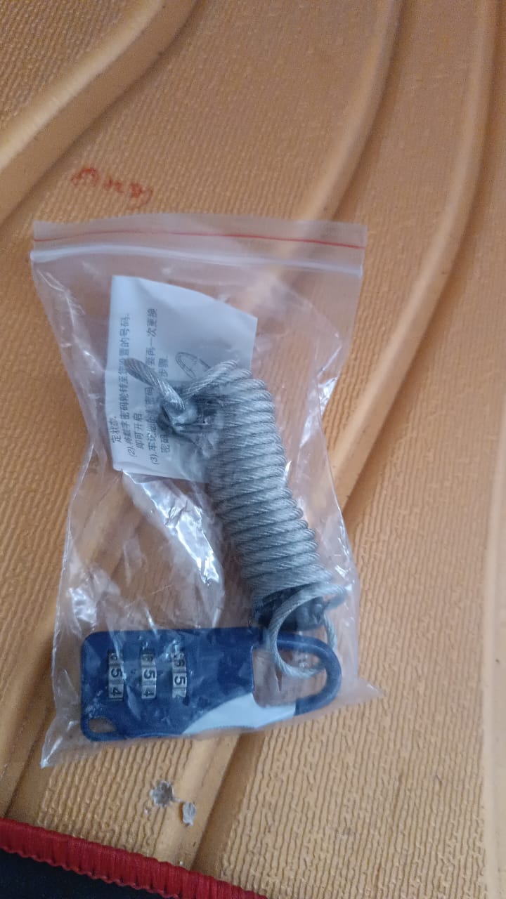 Close detail of anti-theft padlock's steel wire cable coated in PVC