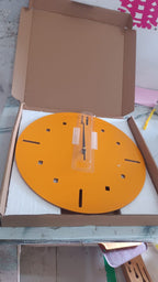 Yellow round wall clock displayed in contemporary room setting