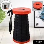 A person easily carrying the lightweight retractable folding stool with its adjustable strap.