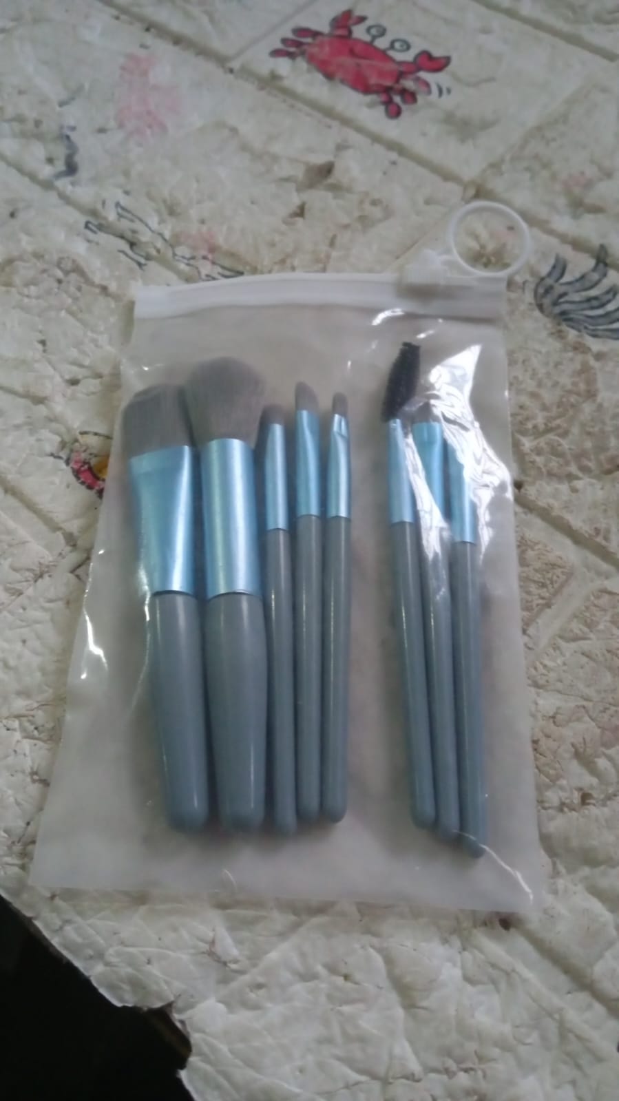 The compact travel case for the mini makeup brush set, perfect for carrying essentials.