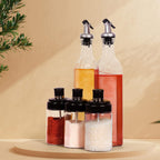  5-piece glass oil dispenser and spice jar set for kitchen storage.